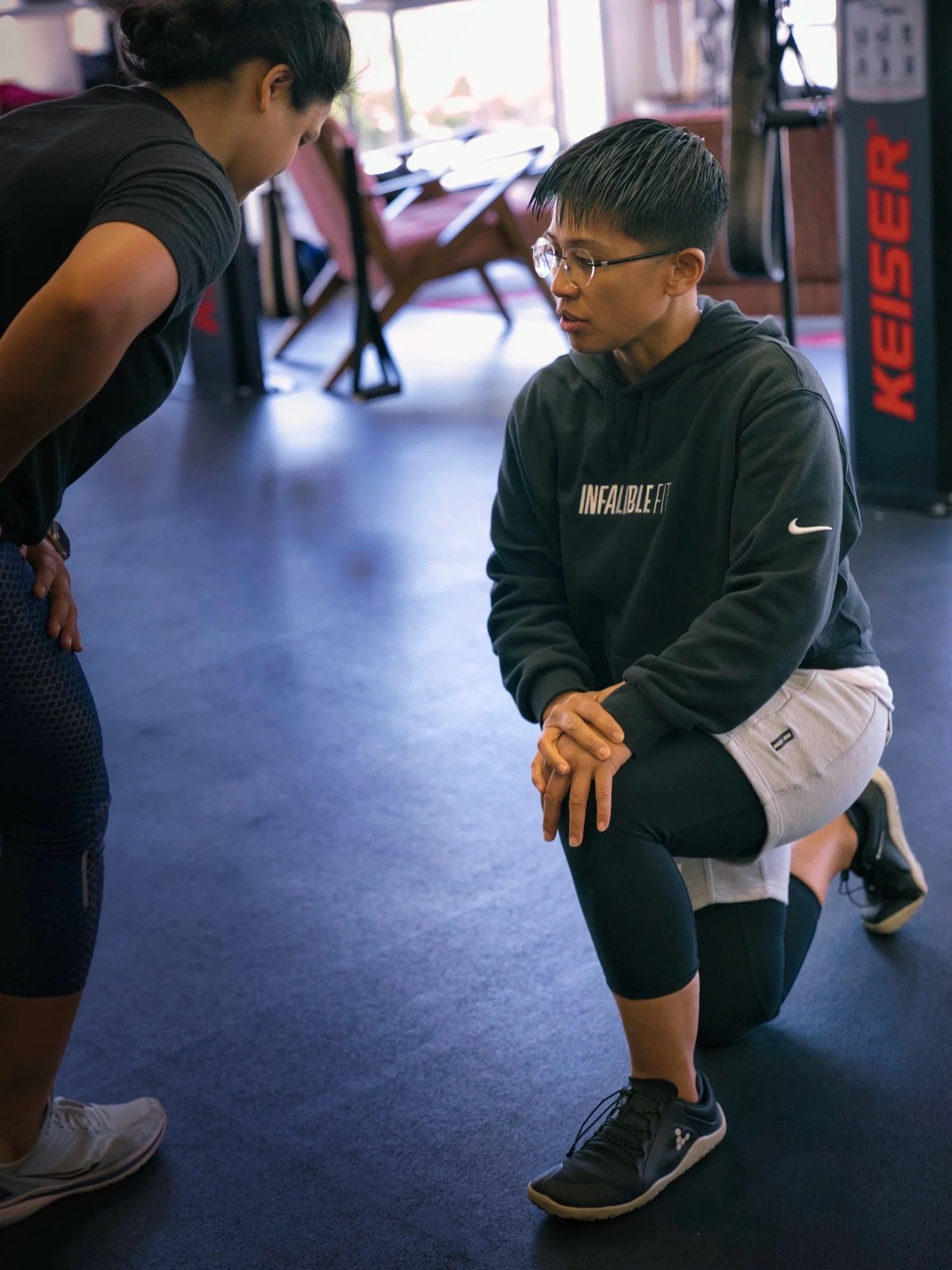 Joanne Castillo guiding a client through strength training.